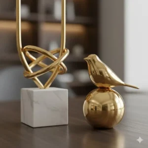 Close up detail of luxury desk statues made from white marble and polished gold metal.